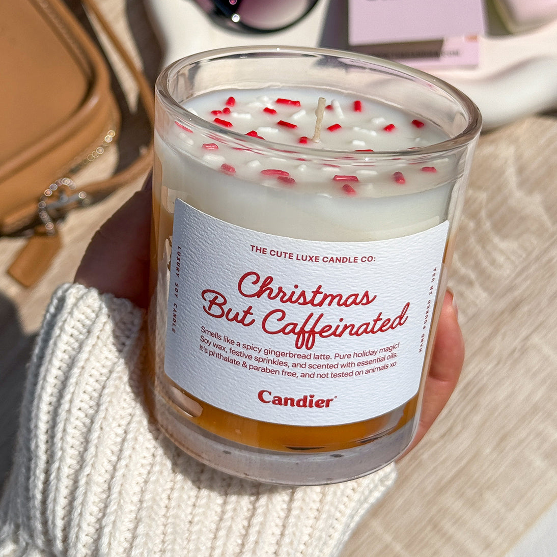 Coffee scented Christmas candle on cozy knit blanket — festive gingerbread latte candle, unique Christmas gifts for adults and coffee lovers.