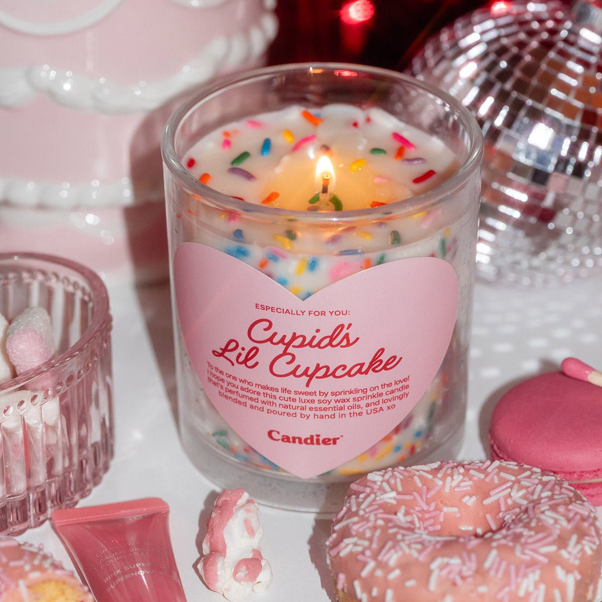 Candier Cupid’s Lil Cupcake Valentine candle styled in pink decor with desserts, a cute and romantic candle gift for her or girlfriend