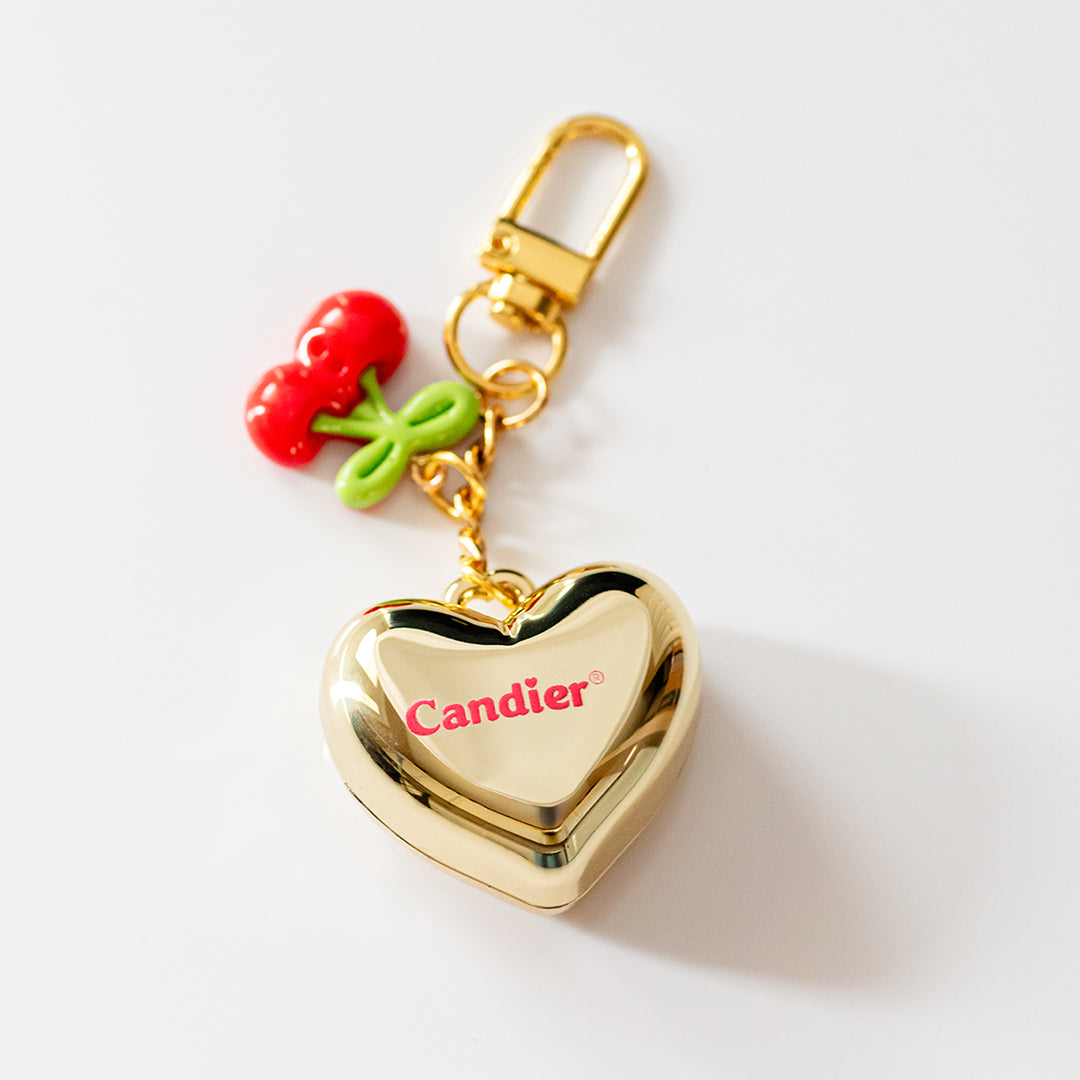 Gold heart locket keychain with cherry charm – stylish lip balm and compact mirror accessory for women
