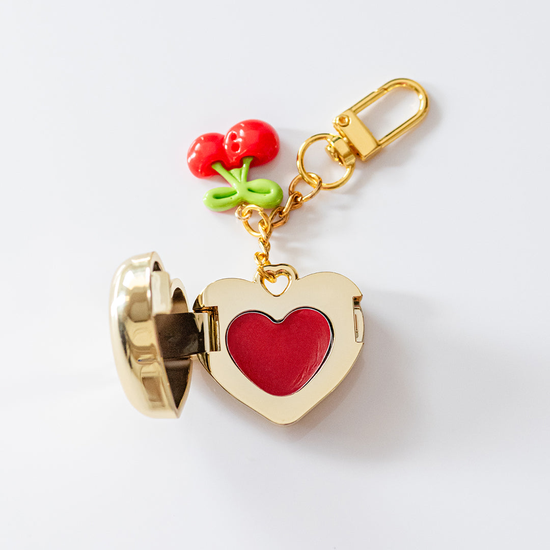 Open gold heart locket with red tinted balm and mirror – perfect cute gift for teen girls