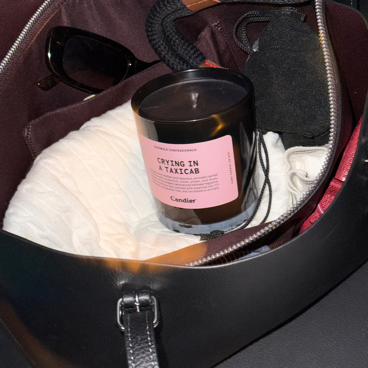 Candier NYC candle at night, luxury candles with moody city aesthetic and woody musk fragrance