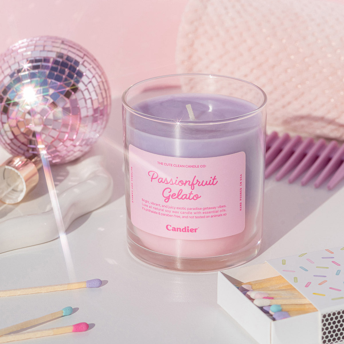 Angled product photo of Candier Passionfruit Gelato Candle showing ombre soy wax and pink aesthetic label—perfect for dessert candle lovers.