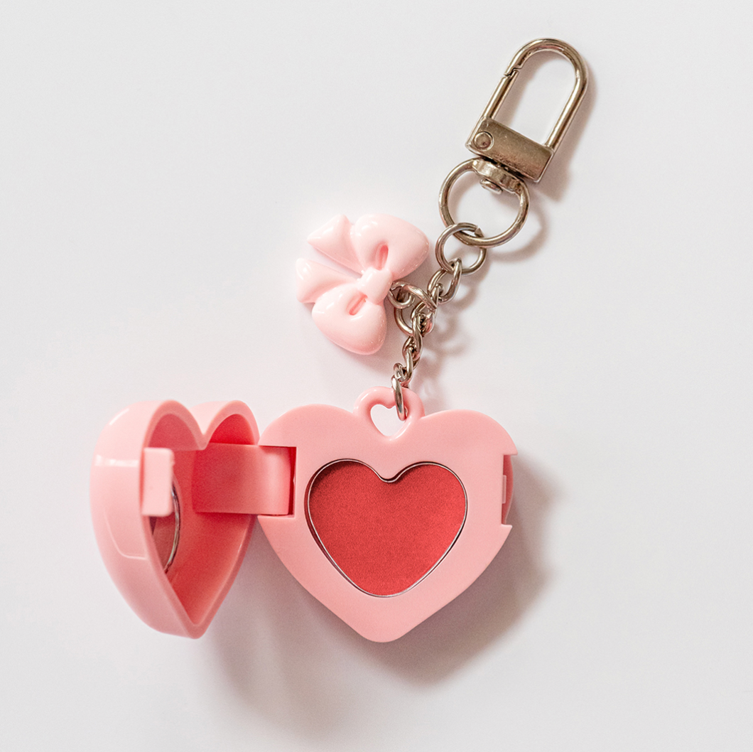 Pink heart keychain locket with open mirror and tinted balm – pretty lips and 90s aesthetic