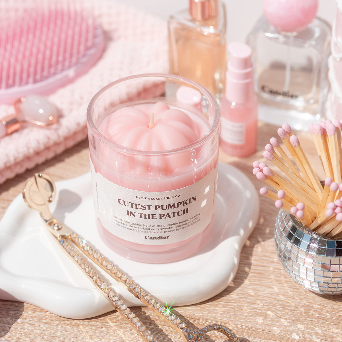 Candier Cutest Pumpkin in the Patch candle styled with soft girl aesthetic perfume bottles. Pretty candles for lux style and best gifts for teen girls.