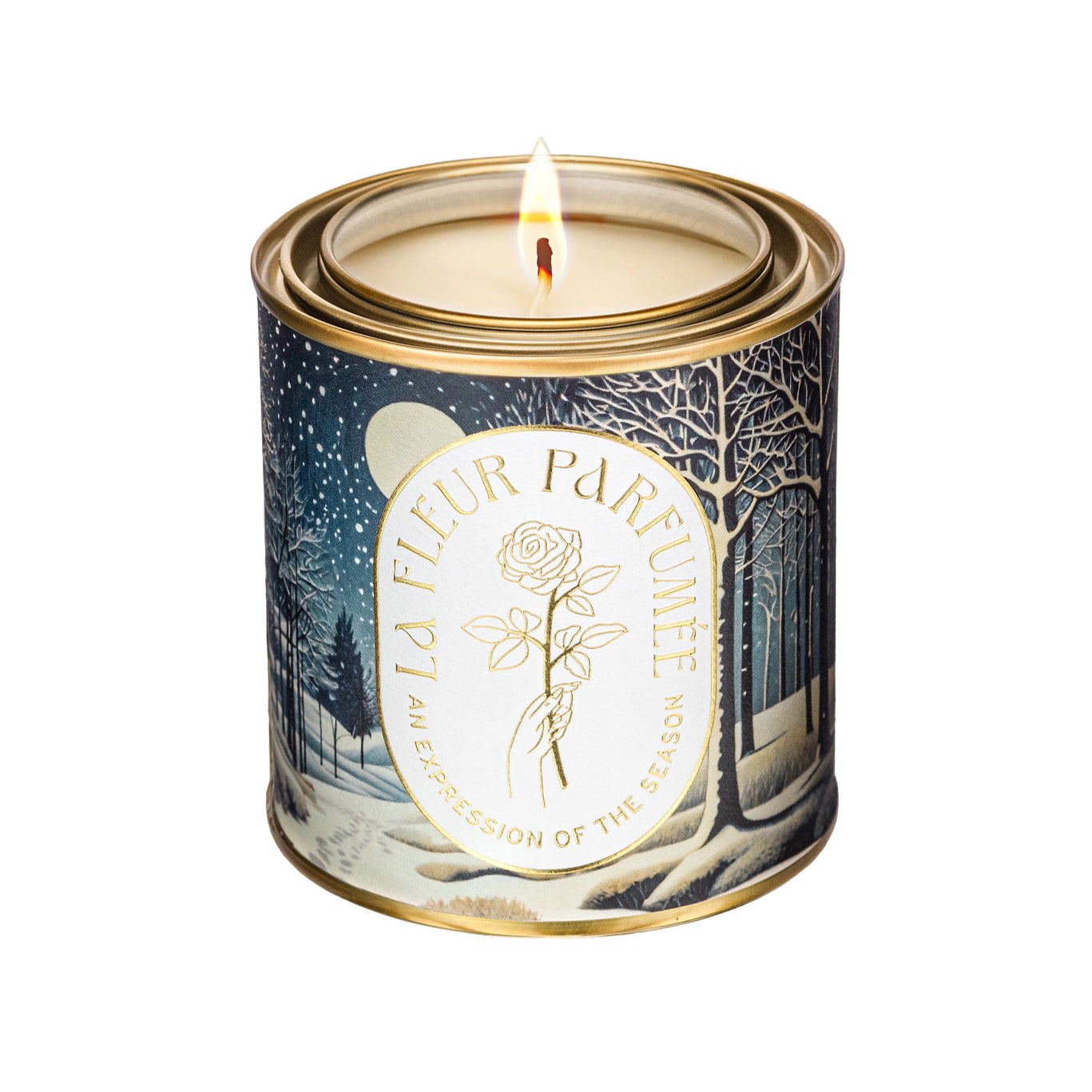 An elegant luxe lit gold-tone candle,  wrapped in artwork of a peaceful winter Candier Winter Solstice — elegant winter candle and christmas scented candle; great for best secret Santa gifts and Hanukkah gifts.