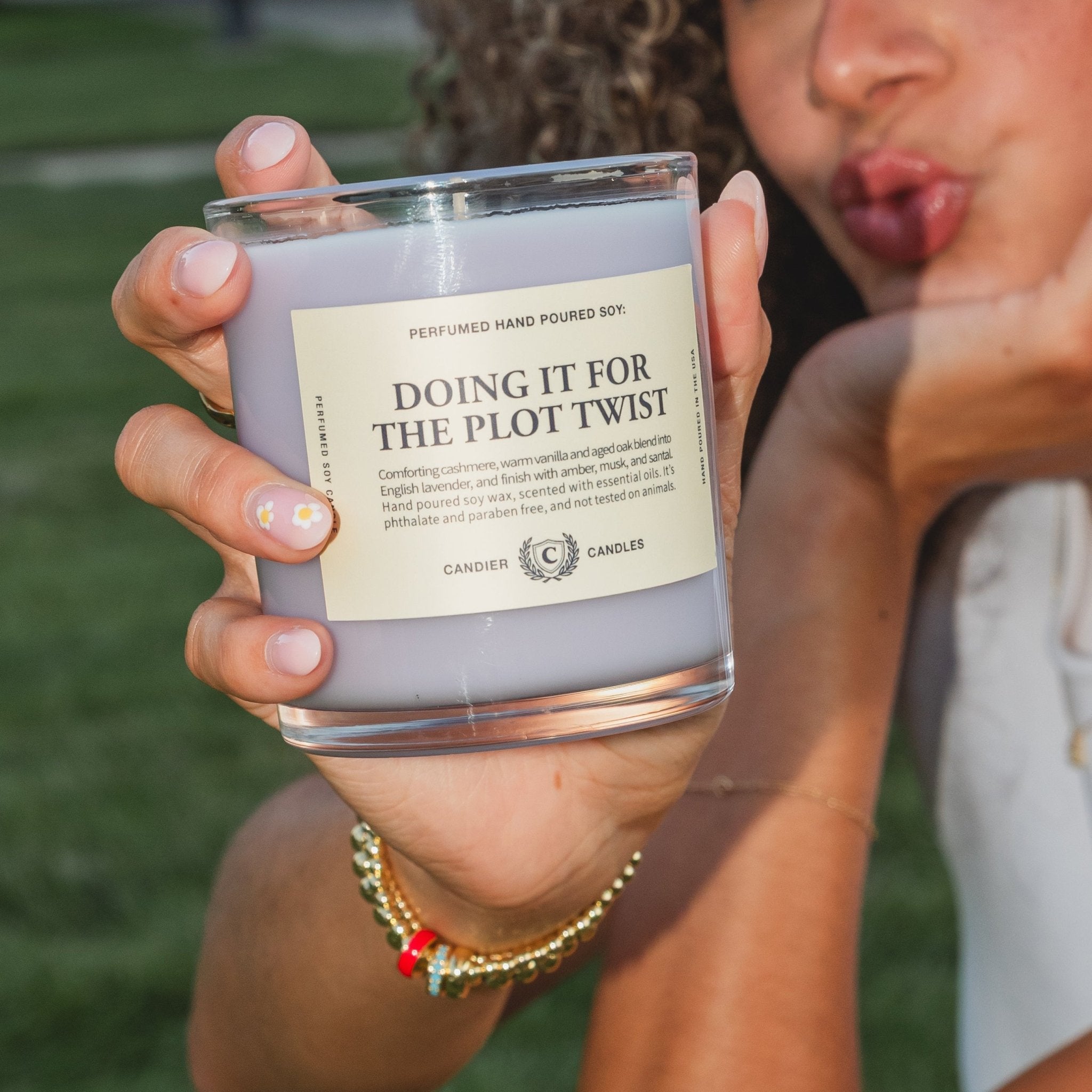 College girl holding Doing It For The Plot Twist candle, a cute college gift