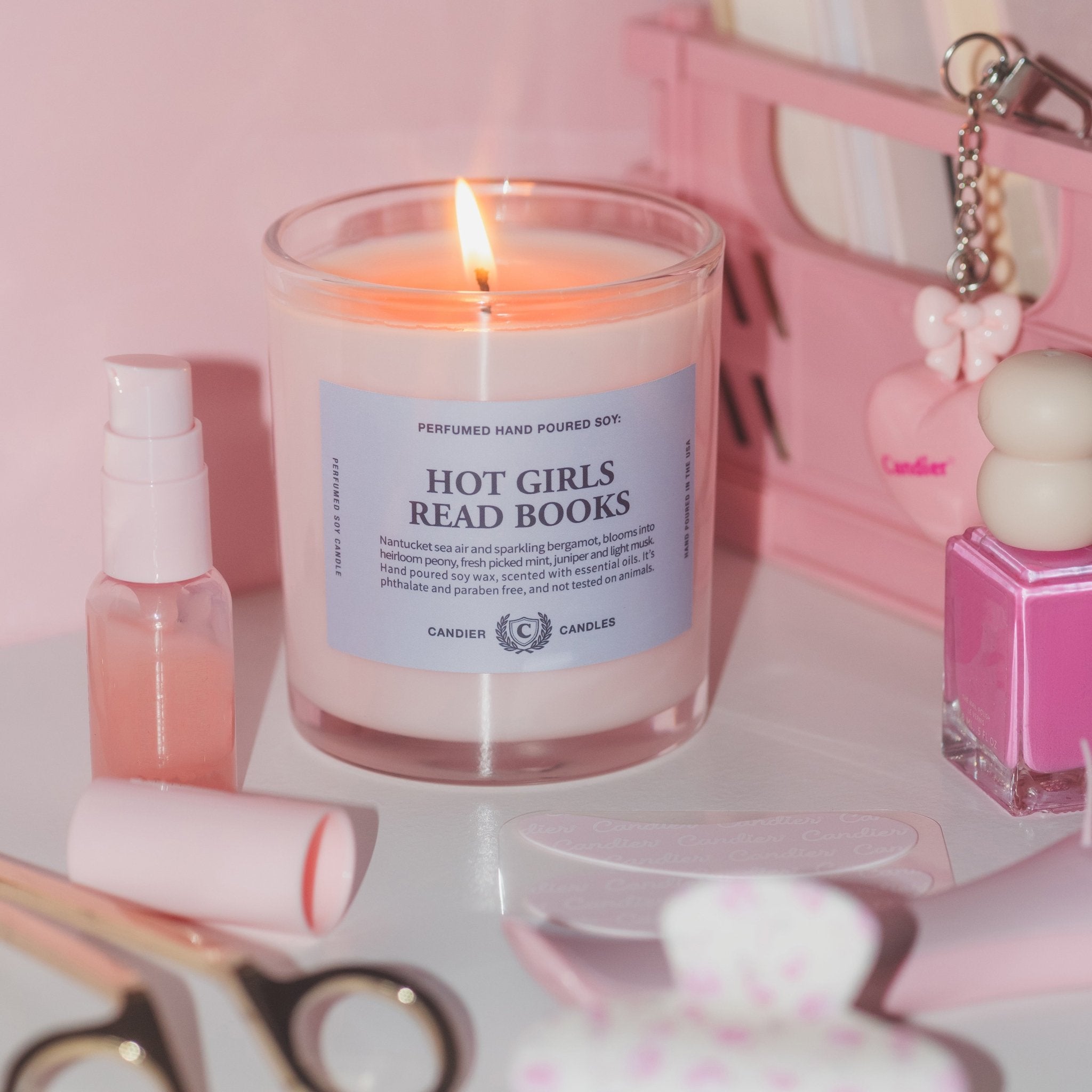 Hot Girls Read Books candle styled with books outdoors, a cute gift for college students and book lovers