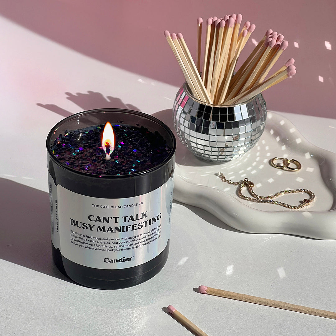 Candier manifestation candle styled on soft pink aesthetic tray with matchsticks. A thoughtful gift with plant-based glitter, perfect for best gifts for teen girls.